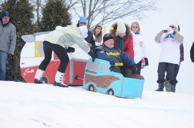 Ice Breaker Festival sled racing with people taking photos