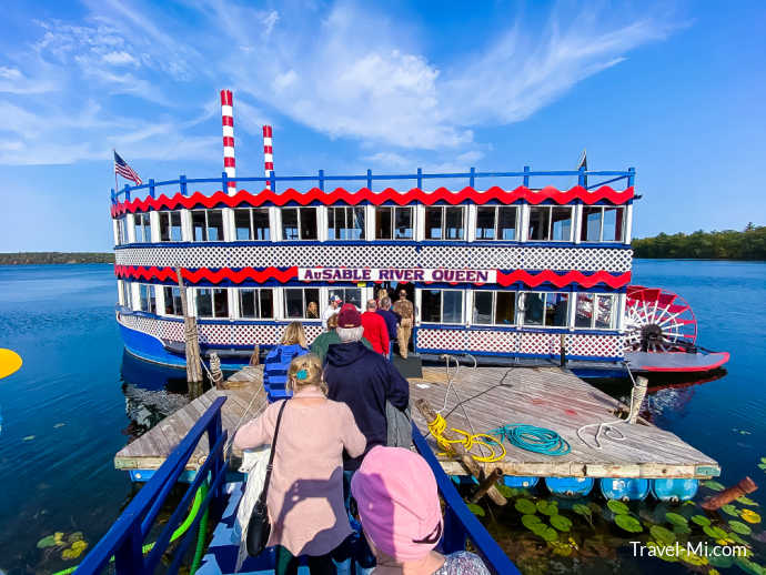 People boarding the red and blue river boat