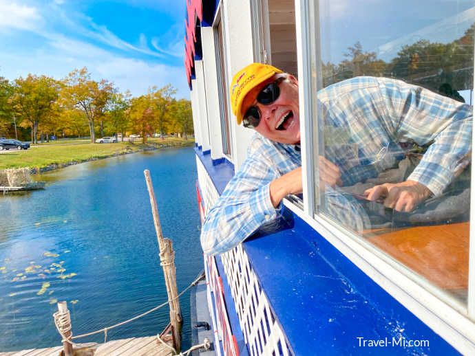 My dad hanging out a window as we depart the dock!