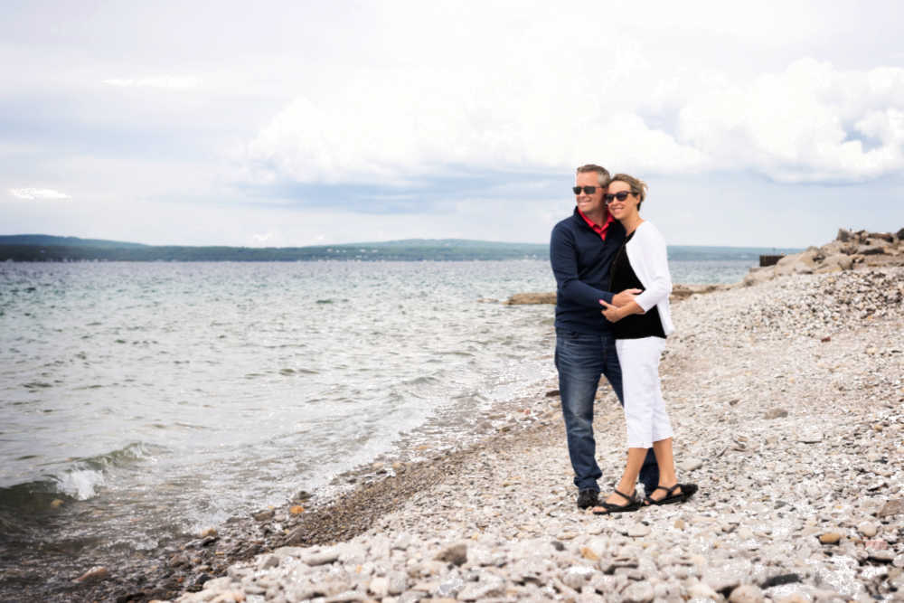 Sherry & Chris are looking out over Lake Michigan at Inn of Bay Harbor