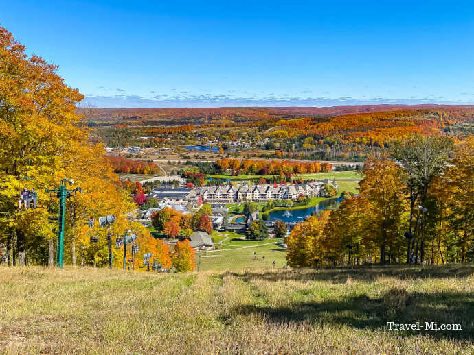 The view from the top of the ski lift is incredible! Colorful trees and resort.