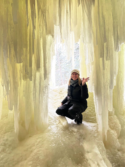 Sherry waving at the camera inside the ice cave