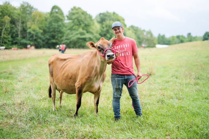 Smiling Farmer at Ankley Farm with a cow