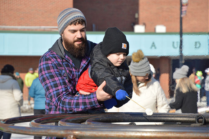 Chilly Fest-A dad and child roasting marshmellows