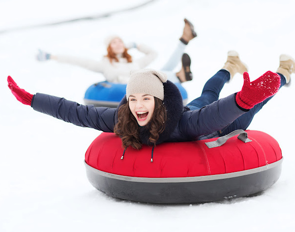 Snow Tubing: Girl on a red snow tube
