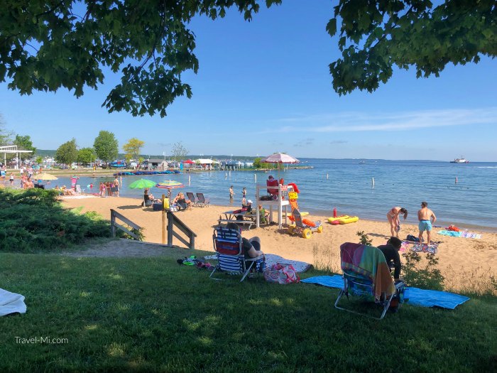 Clinch Park Beach, Traverse City, MI. Sunbathers enjoying the Lake Michigan beach.