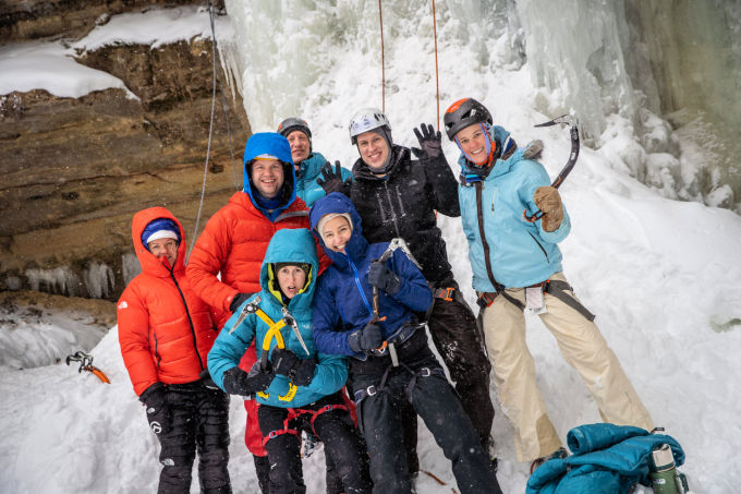 Munising Ice Fest with people posing for a photo while climbing ice