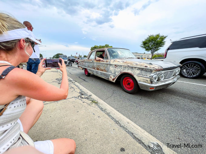 Sherry taking a photo of an old car on Woodward Avenue